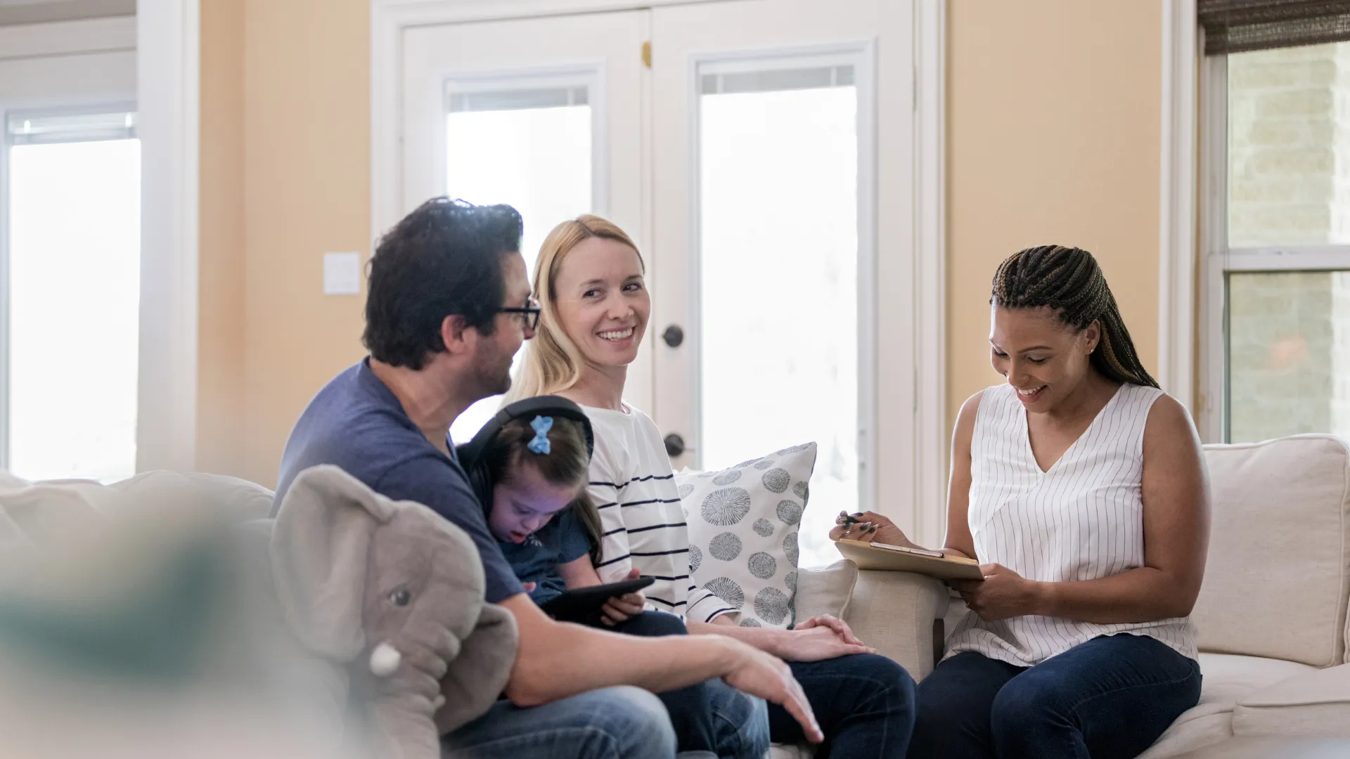 Guide to Adoption “Family meeting with a caseworker in a living room during an adoption support visit