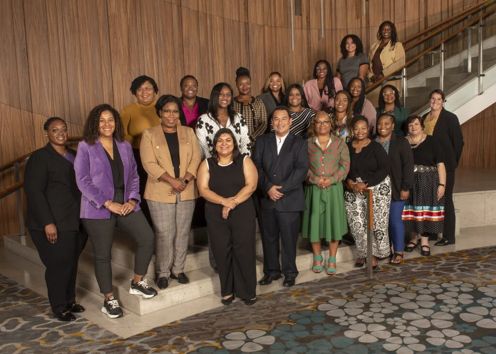 Large group of Adoption Professional Leardership team pose for an offical photo on a staircase.