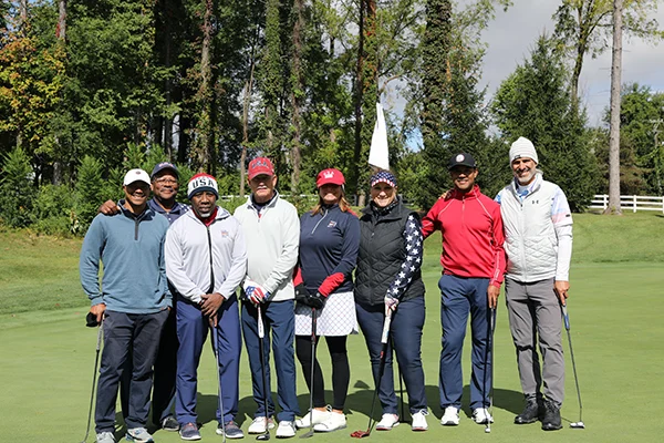 Golfers posing for a picture together for a picture at the Annual Golf Scramble Spaulding Event.